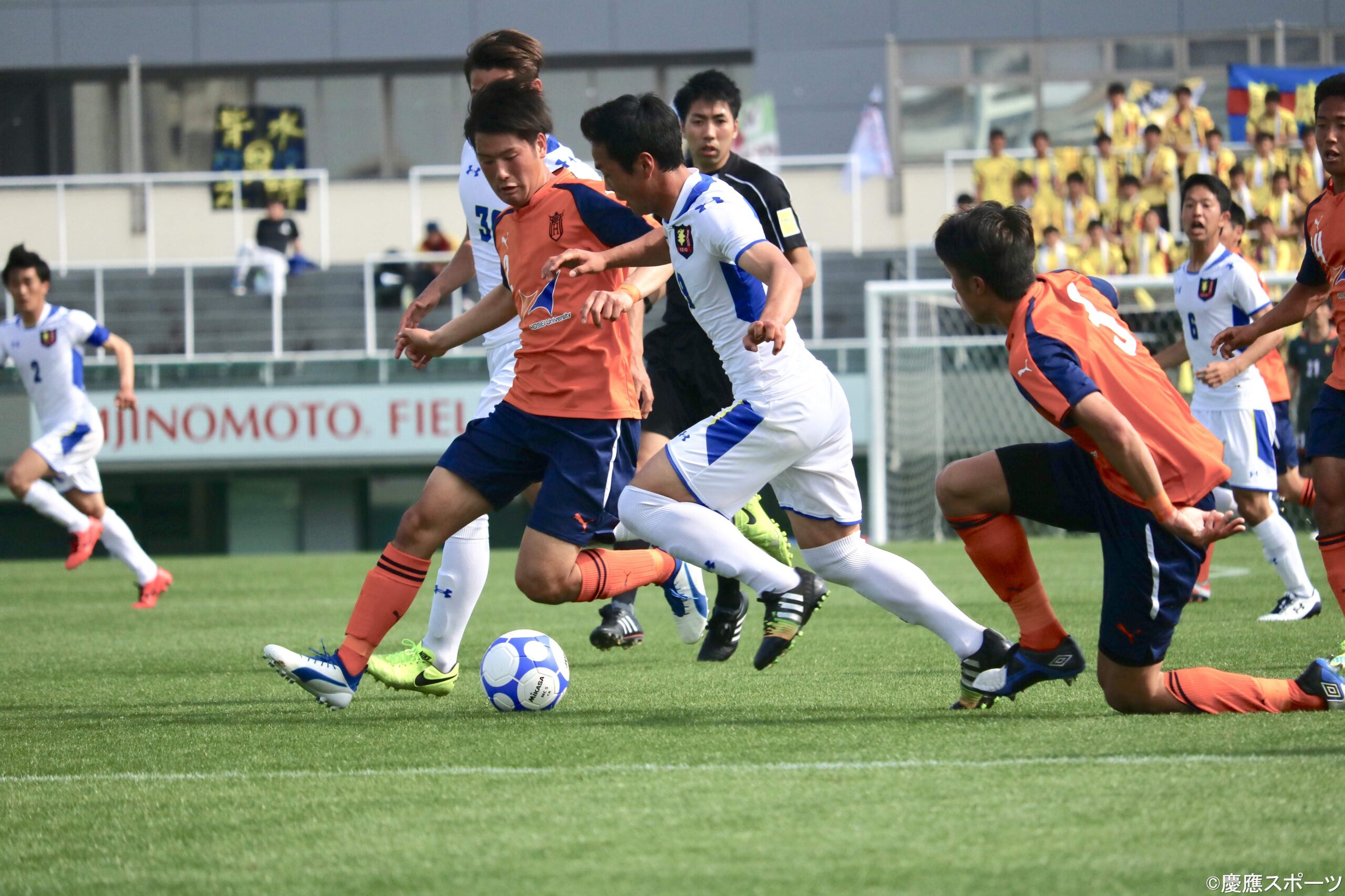 Competitive university football match at Ajinomoto Field
